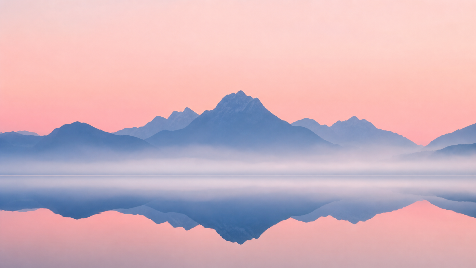 Minimalist dawn landscape with lake and mountain reflection